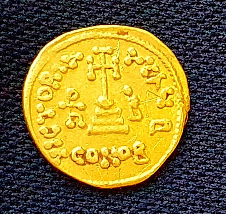 The gold coin that was uncovered in the excavation and has an engraving on it to indicate ownership. Photo by Amir Gorzalzani, Antiquities Authority
