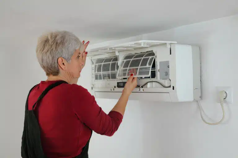 A woman and an air conditioner. Illustration: depositphotos.com