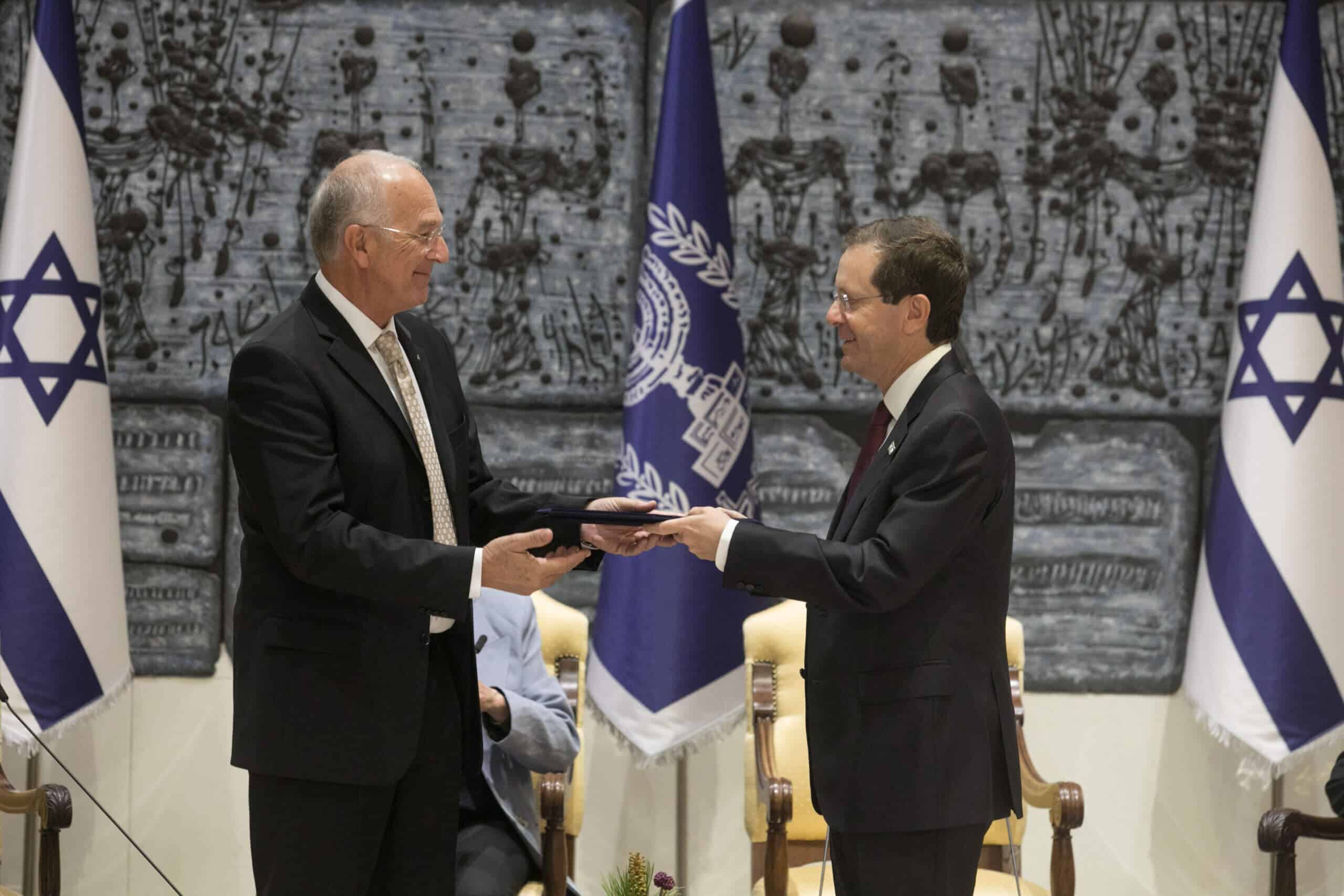State President Yitzhak Herzog presents the letter of appointment to the incoming president of the Academy Prof. David Harel. Photo credit: Israel National Academy of Sciences