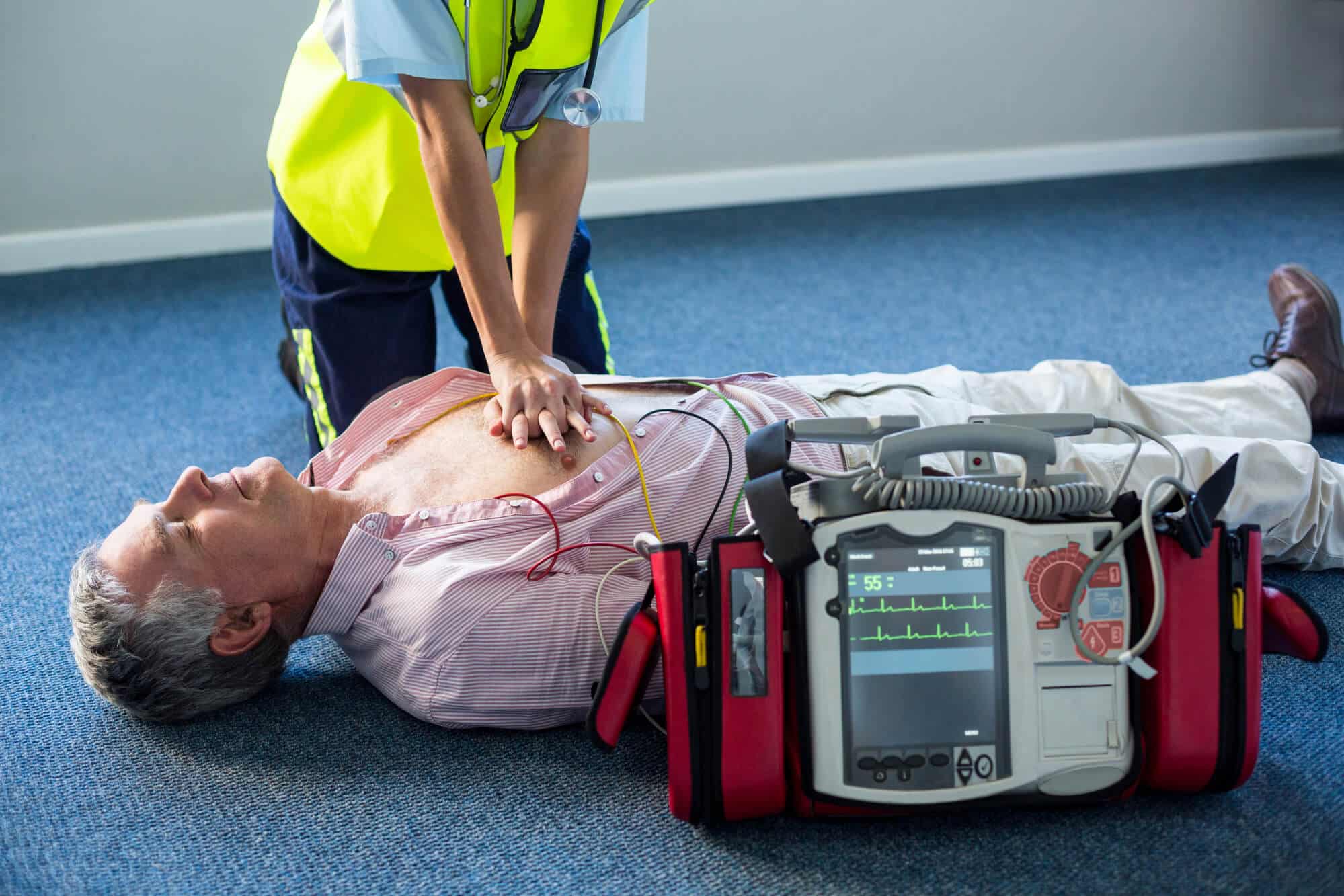 A paramedic treats a cardiac patient using a defibrillator. Illustration: depositphotos.com