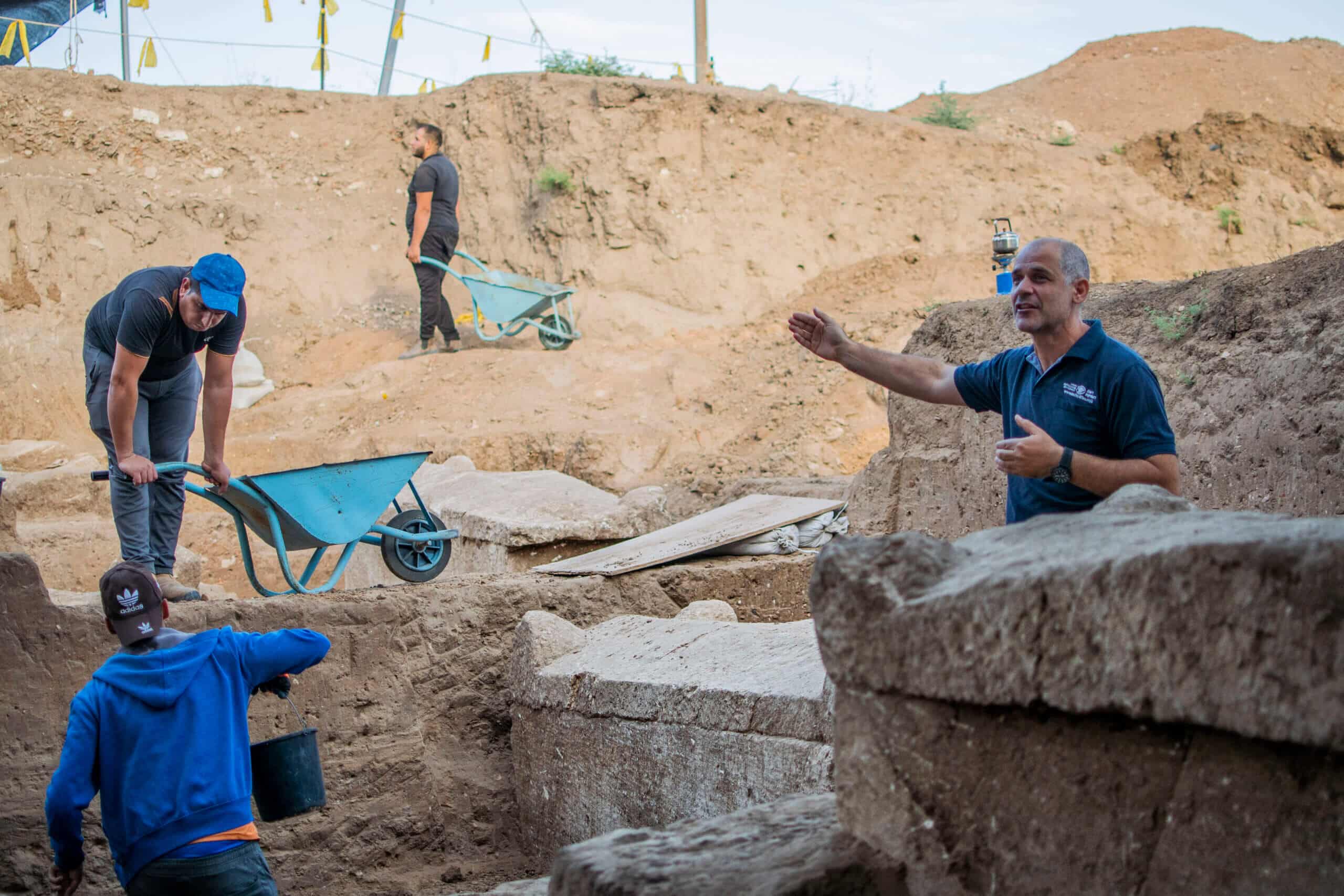Excavation director Pablo Betzer next to coffins from the days of the Sanhedrin. Photo by Yuli Schwartz Israel Antiquities Authority
