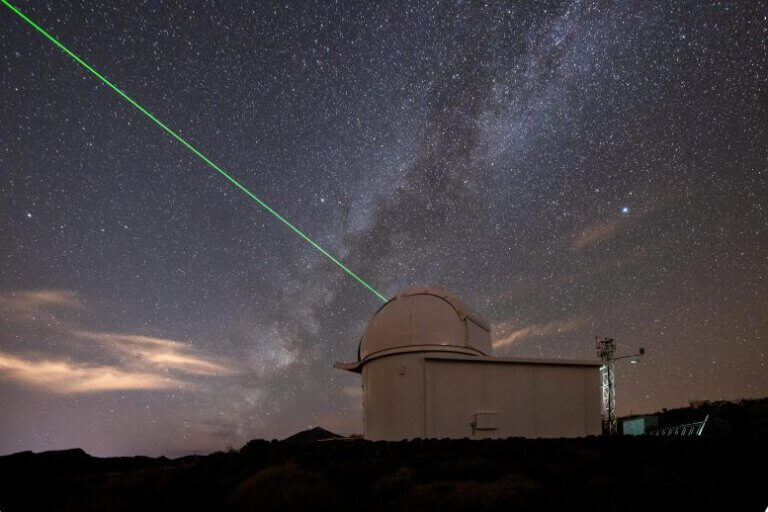 ESA's Laser Ranging Station in Tenerife aims its green laser at the sky. Credit: ESA