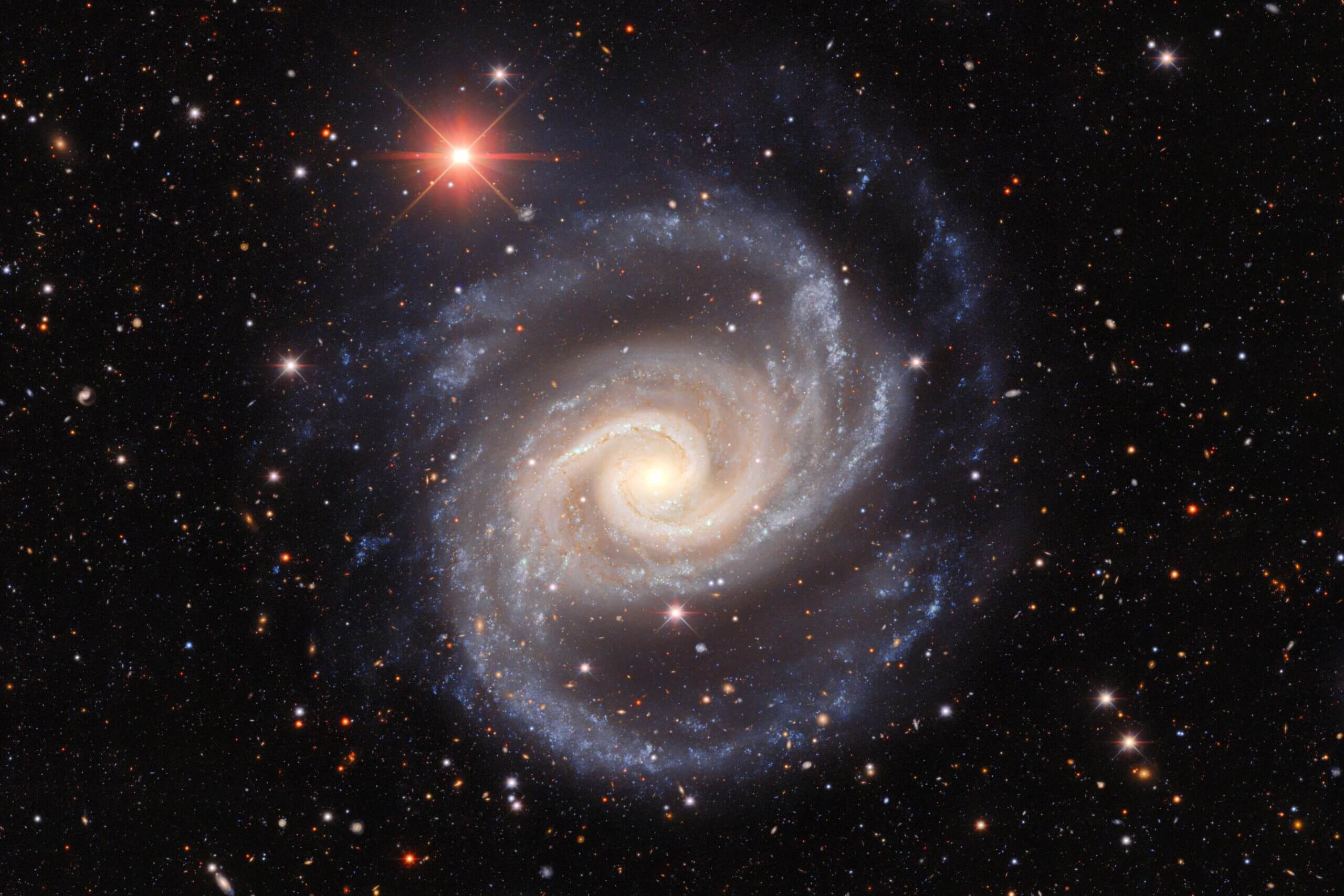This image, taken by astronomers using the dark energy camera on the 4-meter Victor M. Blanco at the Cerro Tulolo Inter-American Observatory captures the galaxy NGC 1566 as it spins and throws its arms through space. The spiral galaxy whose popular name is the Spanish Dancer is often studied by astronomers who study galaxy groups, stars of different ages and galactic black holes. Credit: Dark Energy Survey/DOE/FNAL/DECam/CTIO/NOIRLab/NSF/AURA