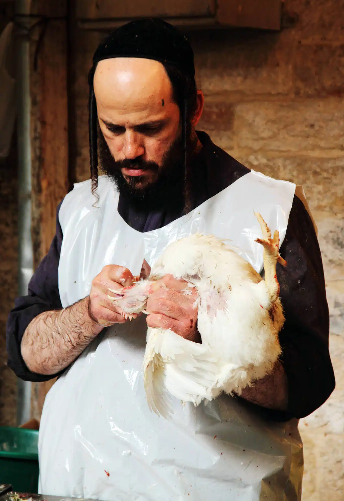A butcher at his craft, the eve of Yom Kippur, Jerusalem. Image: depositphotos.com