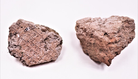 A burnt mud brick from Tel Batsh (Biblical Timna) with markings for measuring the magnetic orientation.