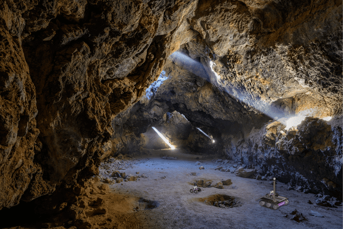Image: In this artist's impression of the breadcrumb scenario, autonomous rovers can be seen exploring a lava tube after being deployed by a mother rover remaining at the entrance to maintain contact with a blimp or blimp. Credit: John Fowler/WikiCommons, Mark Treble Wolfgang Fink/University of Arizona
