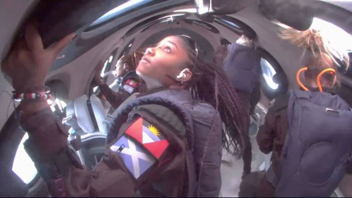 Anastasia Myers while in weightlessness in Virgin Galactic's Unity spacecraft on Commercial Flight 02. In the background is her mother Kisha Shaf with an Israeli flag on her arm. Photo: Virgin Galactic