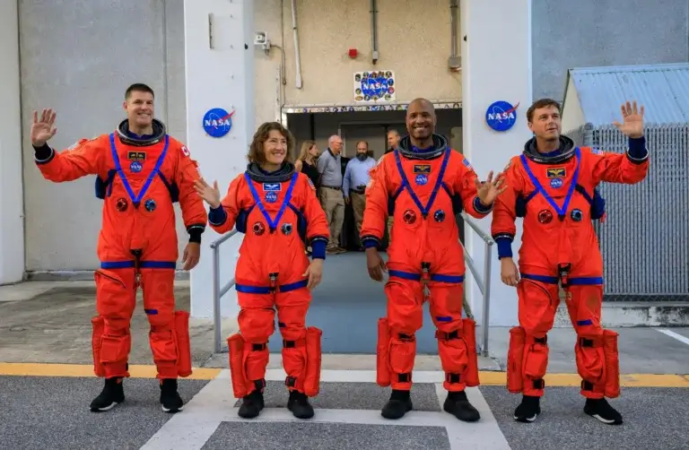 Artemis II crew members (from left) CSA (Canadian Space Agency) astronaut Jeremy Hansen, and NASA astronauts Christina Koch, Victor Glover and Reid Weisman, exit the astronaut crew quarters in the Neil Armstrong Building to the Artemis crew transport facilities, before traveling to Launch Pad 39B As part of the Integrated Ground Systems Experiment at the Kennedy Space Center in Florida, on Wednesday, September 20, to test the crew's schedule on launch day. Now they will have to wait another year for the actual flight. NASA photo