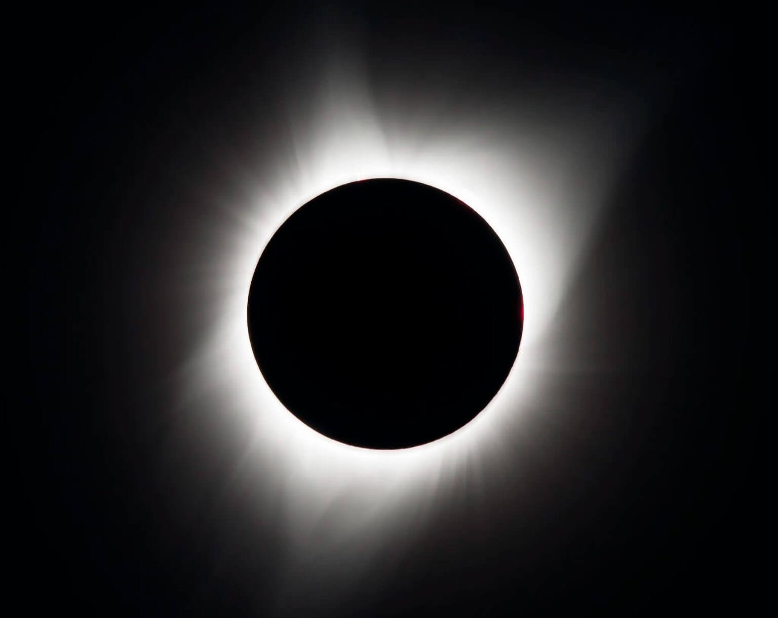 The August 21, 2017 total solar eclipse was photographed from Madras, Oregon. The black circle in the middle is the moon. Around it are streams of white light that belong to the sun's outer atmosphere, called the corona. Credit: NASA/Aubrey Gamaniani