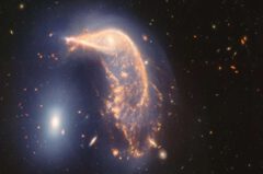 This "penguin party" is loud. The twisted spiral galaxy in the center, known as the Penguin, and the compact elliptical galaxy to the left, known as the Egg, are in an active embrace. A new near- and mid-infrared image from the James Webb Space Telescope, taken to mark two years of scientific activity, shows that their interaction is marked by a subtle, inverted U-shaped blue glow. Credit: NASA, ESA, CSA, STScI