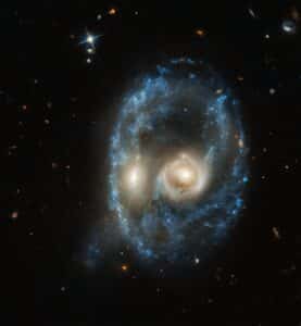 Two galaxies collide in the Arp-Madore 2026-424 system, creating an appearance reminiscent of a face.